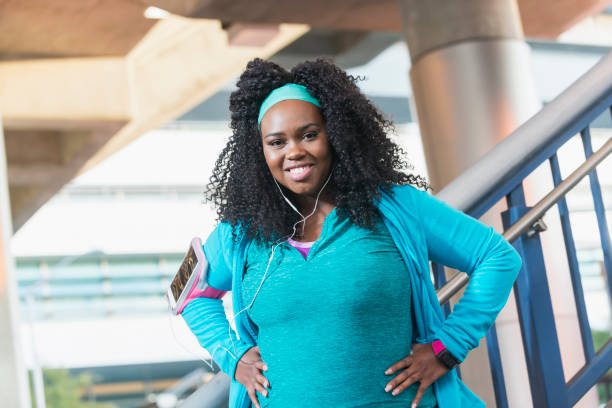 istock Young black woman in workout clothing, hands on hips 679993704