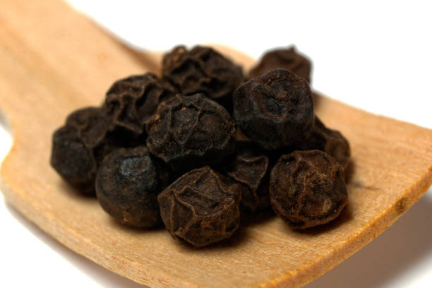 istock black pepper on wooden spoon 680006980