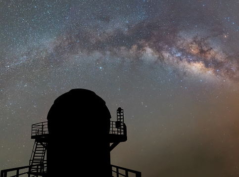 observatory with milky way galaxy, long exposure photograph, with grain