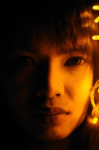 istock Portrait beautiful young woman face with small lights 680016612