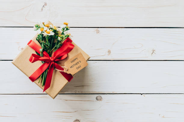 istock gift box and flower on wood table present 680018946