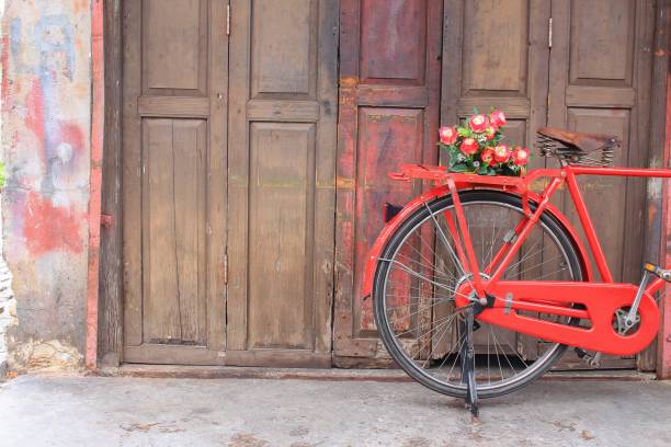 istock flower on saddle red bicycle classic vintage on wall wood background 680019646