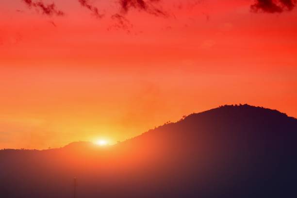 Sunset in sky and cloud,  beautiful colorful  twilight  time with mountain silhouette