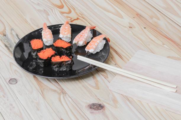 istock Sushi in plate black on wooden background 680031394