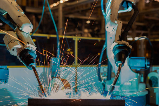 istock Close up team robots are welding in factory 680032024