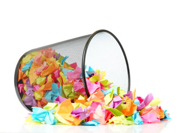 istock Black metal trash with colored paper on white background 680048344