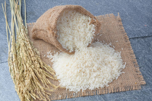 istock thai fragrant jasmine rice in a spoon with gold spike on Sack 680050944