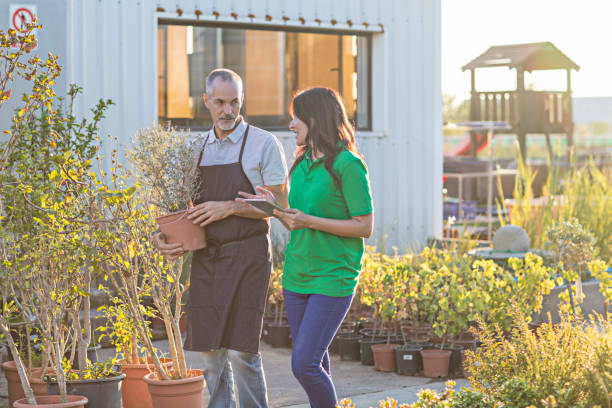 istock Worker discussing with colleague at garden center 680050976