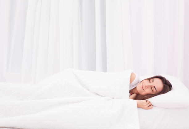 istock Beautiful young woman sleeping in white bed 680053962