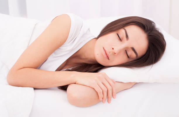 istock Beautiful young woman sleeping in white bed 680053974