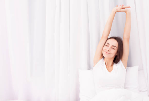 istock Woman stretching in bed after wake up 680054050