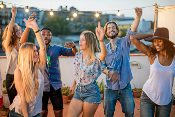 istock Happy friends are dancing while enjoying party 680056470