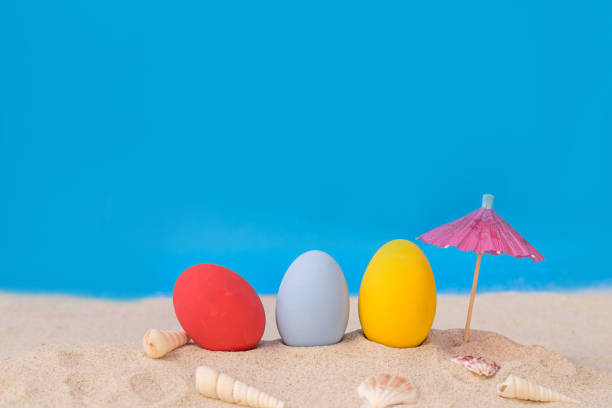 istock colorful eggs on white sand beach over cloudy sky 680058602