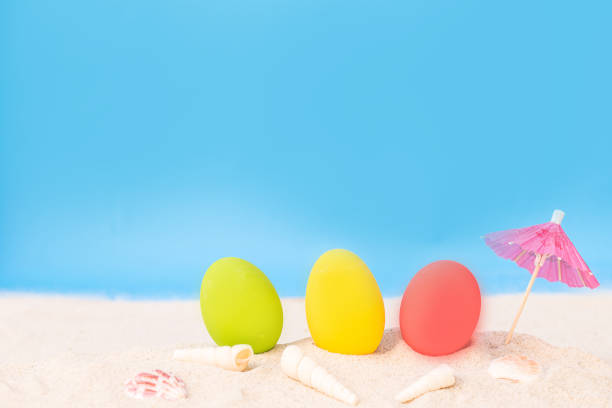 istock colorful eggs on white sand beach over cloudy sky 680058736