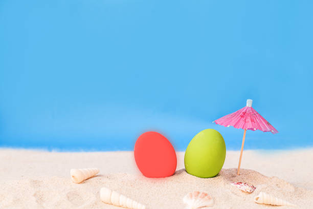 istock colorful eggs on white sand beach over cloudy sky 680058816