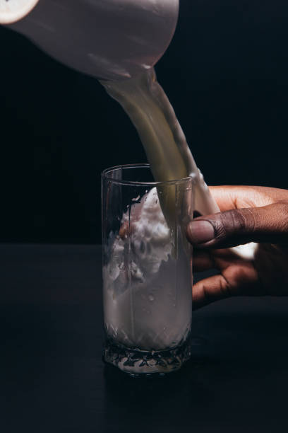 istock Unrecognizable person pour milk in glass, close up 680059850