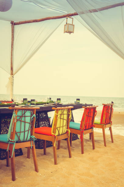 istock Table and chair set on the beach for dinner 680064998