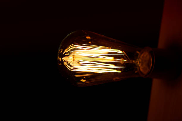 istock Edison light bulb hanging on a long wire. Cozy warm yellow light.Retro 680067140