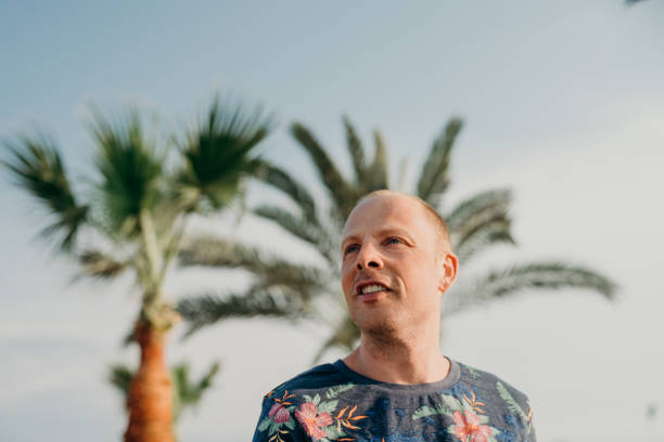 istock Man on vacation walking by the sea on sunny day 680067354