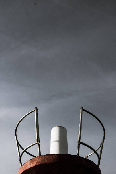istock Red tower with chrome circular railing against a dark sky 680068240