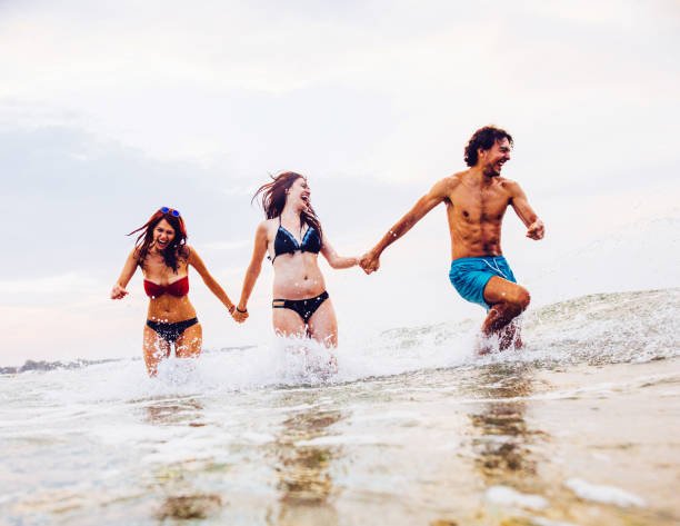 istock Friends having fun in the sea 680071084