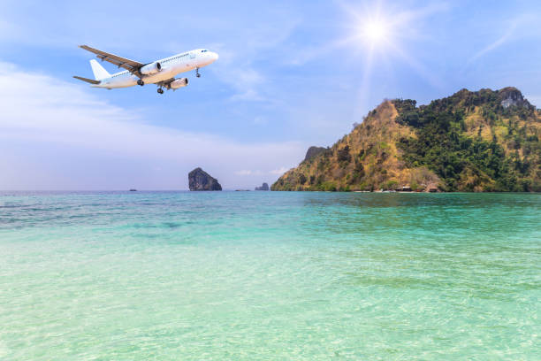 istock passenger airplane landing above small island with sunlight. 680077922