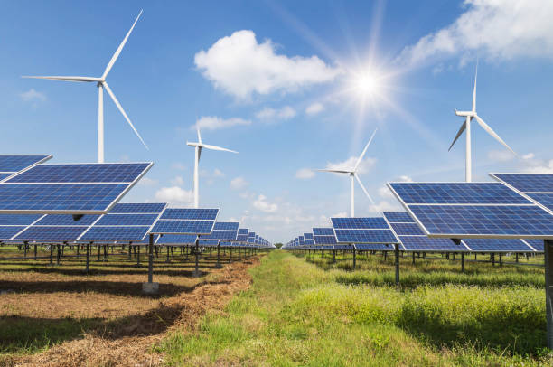 istock solar panels and wind turbines generating electricity in power station 680079224
