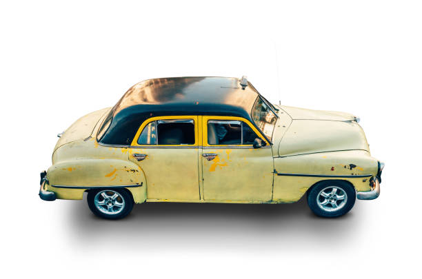 an old abandoned and damaged car parked in the backyard. classic vehicle