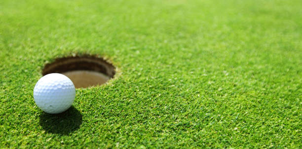 istock golf ball on lip of cup 680082042