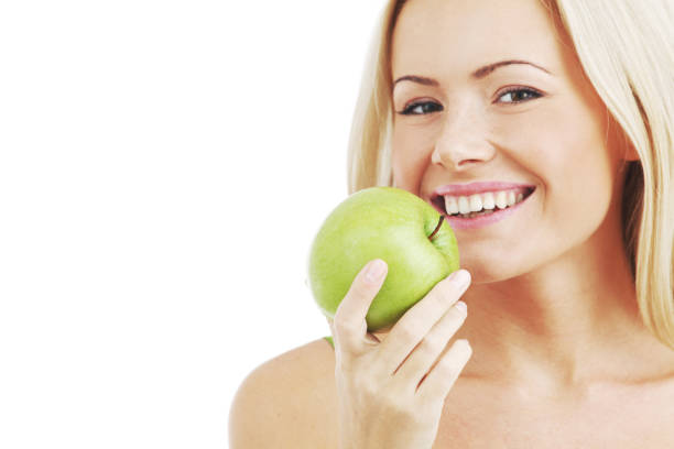 istock woman eat green apple 680082122