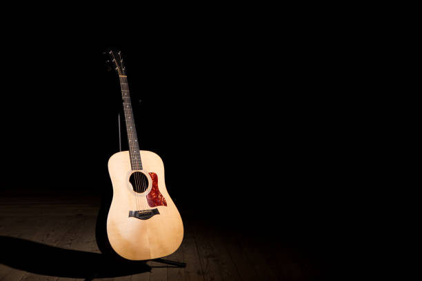 istock Acoustic guitar over dark background with copy space 680097546
