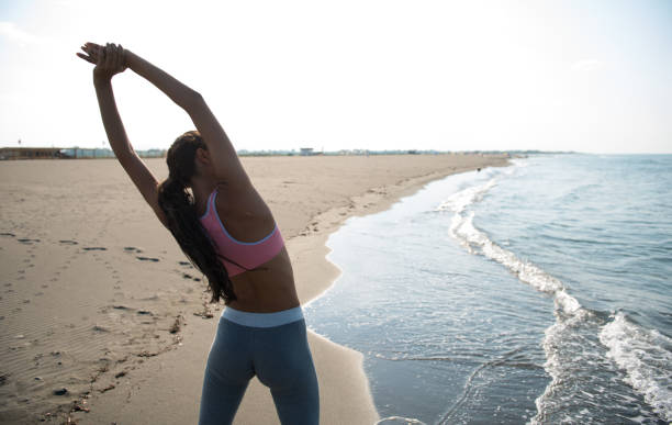 istock Woman stretching out at the beach. 680097586