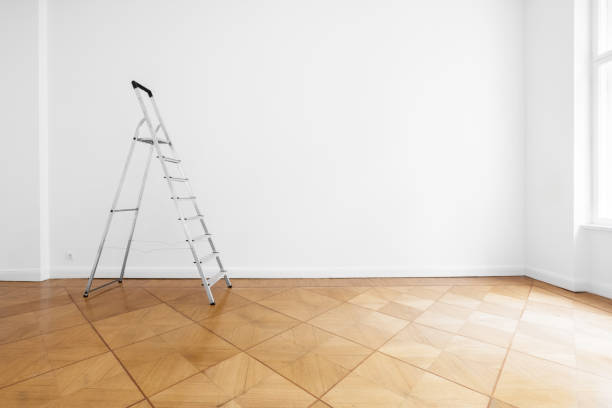 Two ladders are standing next to the door
