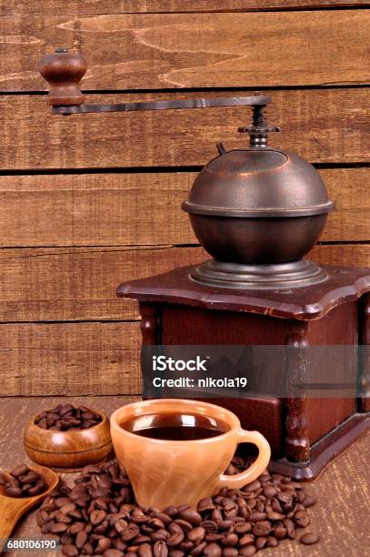 Old Wooden Coffee Grinder And Roasted Coffee Beans On A Wooden Table Fresh Hot Coffee In Cup Stock Photo - Download Image Now