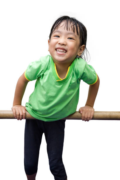 asian chinese little girl hanging on horizontal bar - gymnastics smiling little girls only isolated on white imagens e fotografias de stock