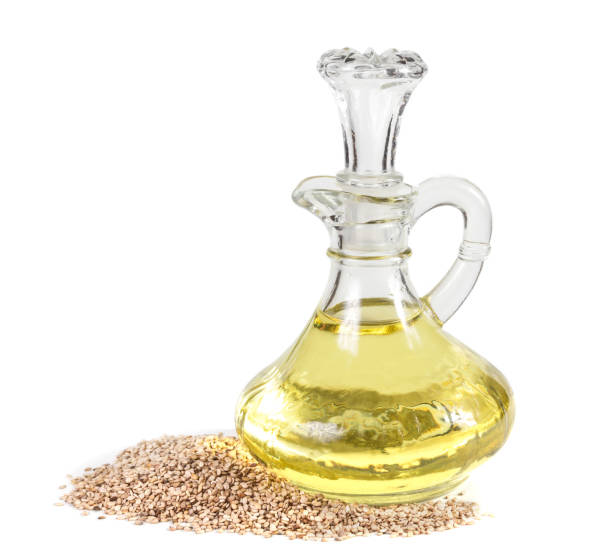 istock Jug with sesame oil and sesame seeds on white background 680122116