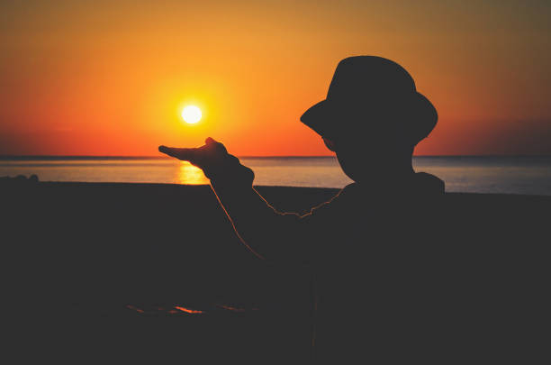 istock Silhouette of a boy in a hat at sunset 680122726