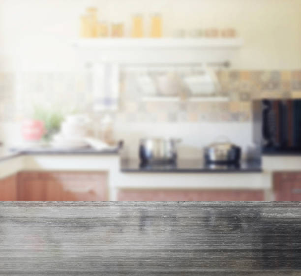 istock black granite table top and blur of modern kitchen interior as background 680124754