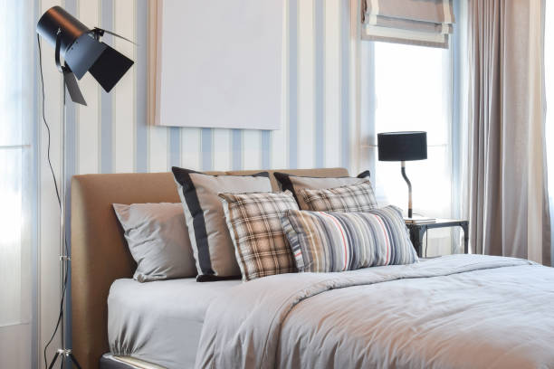 istock stylish bedroom interior design with striped pillows on bed and decorative lamp. 680132010