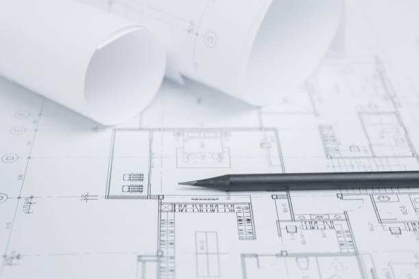 istock black pencil on architectural drawing paper and rolls for construction 680134412