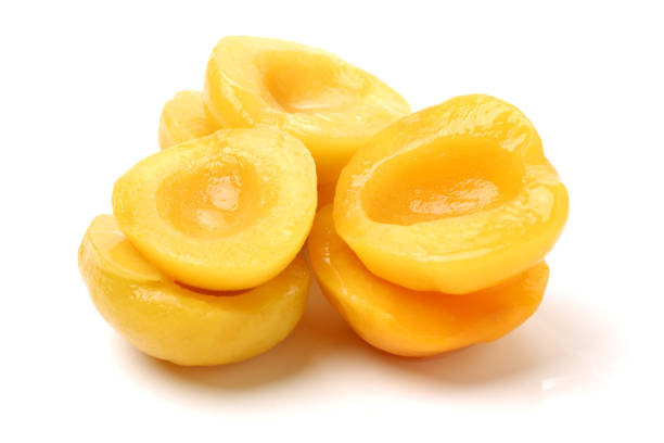 istock Canned peach on syrup over white background 680134622