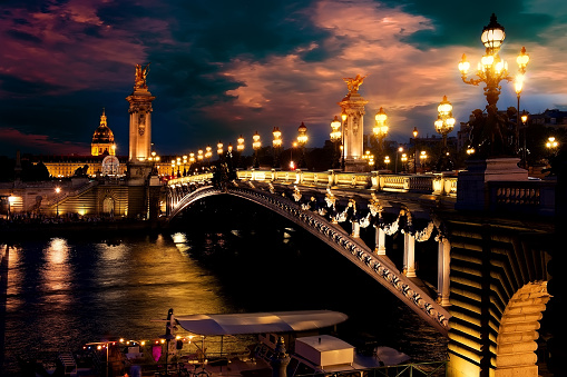Night over Alexandre III bridge in Paris, France