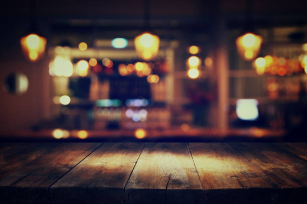 istock wooden table in front of abstract blurred restaurant lights 680134964