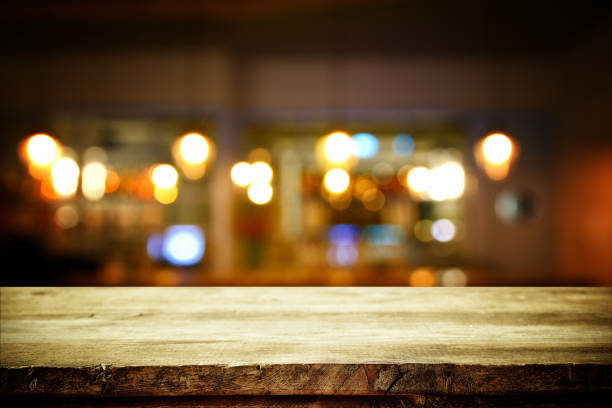 istock wooden table in front of abstract blurred restaurant lights 680135526