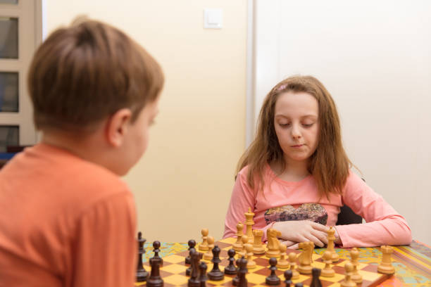 istock Brother and sister playing chess 680138234