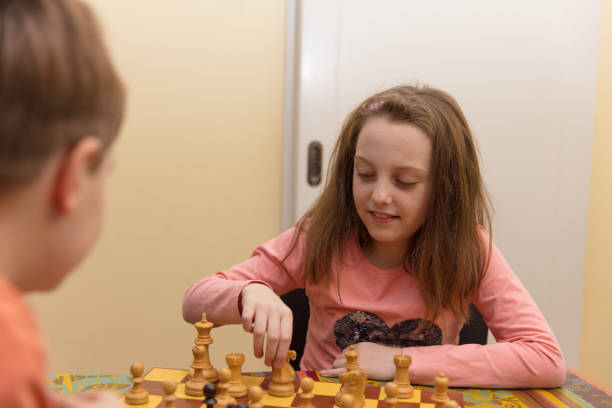 istock Brother and sister playing chess 680138584