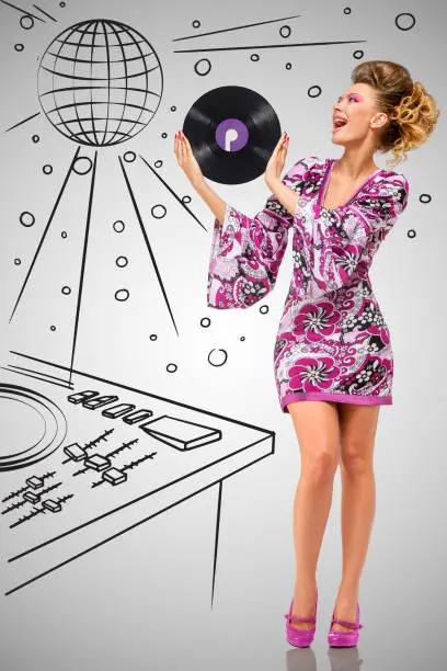 Colorful photo of a clubbing fashionable hippie deejay at the nightclub holding a retro vinyl record in her hands on grey sketchy background of a DJ mixer and disco ball.