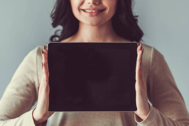 istock Beautiful young woman with gadget 680140892