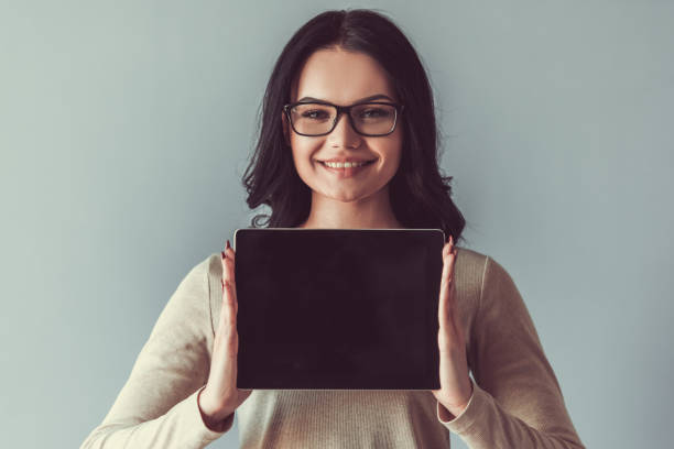 istock Beautiful young woman with gadget 680141204