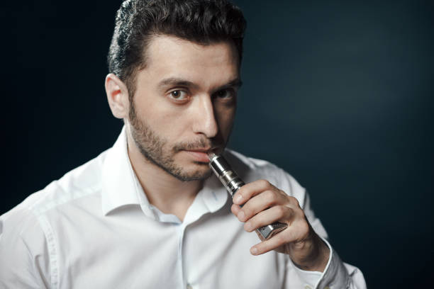 istock Caucasian man in white shirt vaping 680141632